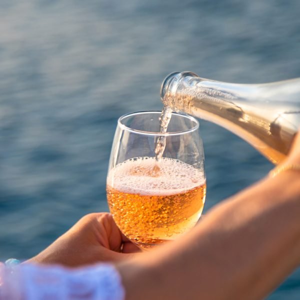 Wine in a glass on the seashore. Selective focus. Travel.
